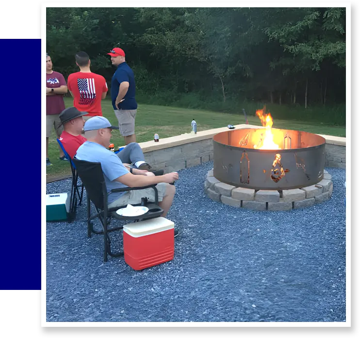 Friends gather around a fire pit.