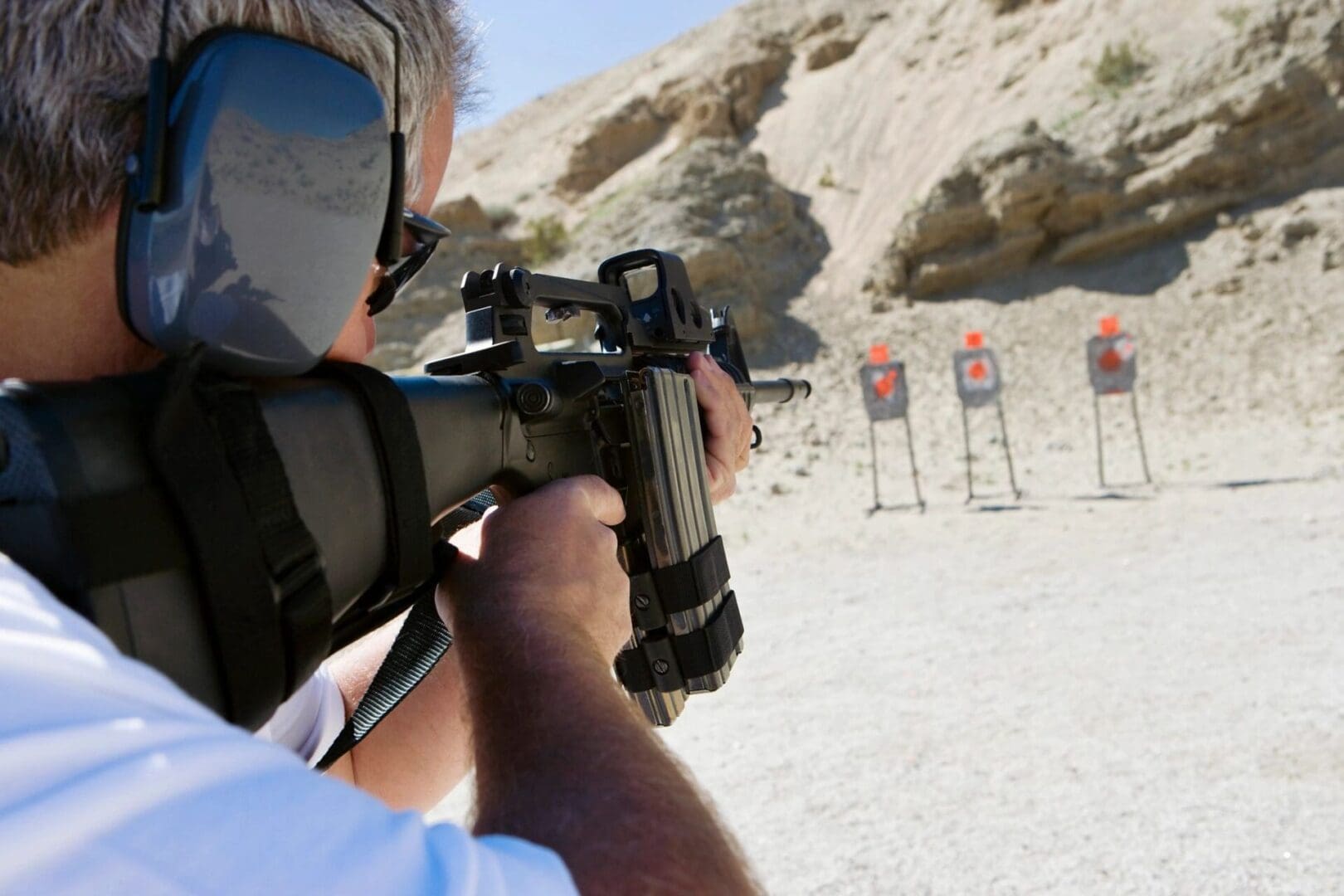 Man shooting rifle at targets.