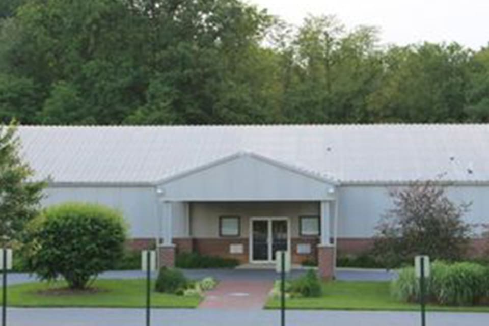 A white building with a front porch.